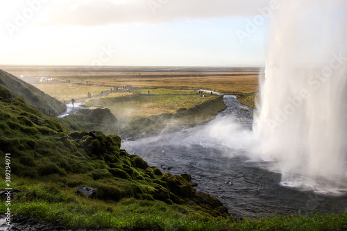 SELJALANDSFOSS, ICELAND - SEPTEMBER 19, 2018: Seljalandsfoss waterfall on Seljalands River in South Iceland, its one of the most famous and visited waterfalls in Iceland. Photographed from behind.