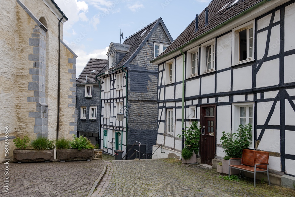 Outdoor street view of small town with traditional German wooden townhouses around Neviges Church in Velbert, Germany.