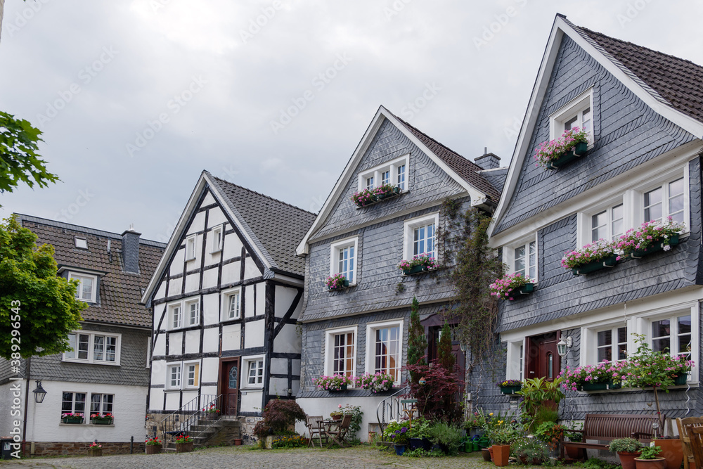 Outdoor street view of small town with traditional German wooden townhouses around Neviges Church in Velbert, Germany.