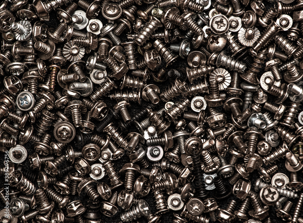 A background of silver screws and bolts. Various screws. Hardware A background of silver screws and bolts. Various screws. Hardware