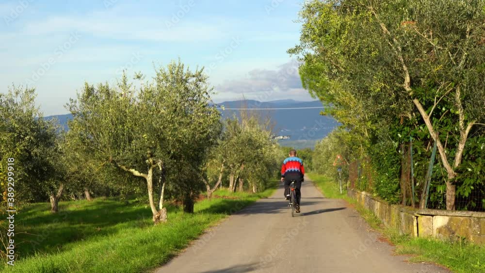 A cyclist boy travels the Chianti roads A cyclist boy travels the Chianti roads