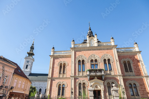 Facade of Vladicanski Dvor, the Bishop Episcopal palace of Novi Sad, Serbia, with its typical Austro hungarian architecture, with the Saborna crkva church, an Orthodox cathedral, in the background