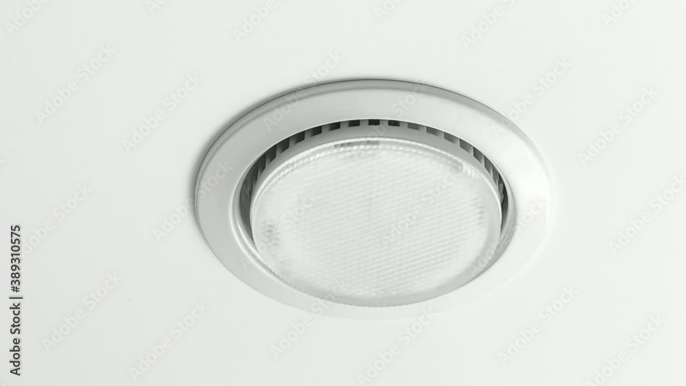 Close-up of a recessed LED luminaire on a white ceiling. Close-up of a recessed LED luminaire on a white ceiling.
