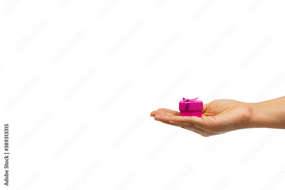 Women's hand holding small gift box isolated on white background Women's hand holding small gift box isolated on white background