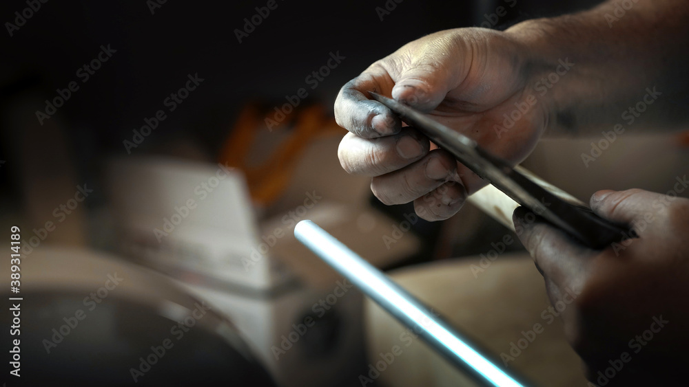 The man checks the sharpness of the ax with his finger The man checks the sharpness of the ax with his finger