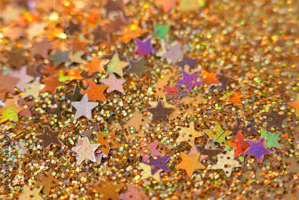 New Year and Christmas  texture.Wallpaper  shining glitter phone.Gold stars in gold glitter.Winter festive background with golden bokeh.Golden glitter festive background