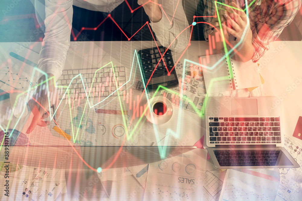 Double exposure of man and woman working together and financial chart hologram drawing. market analysis concept. Computer background. Top View. Double exposure of man and woman working together and financial chart hologram drawing. market analysis concept. Computer background. Top View.