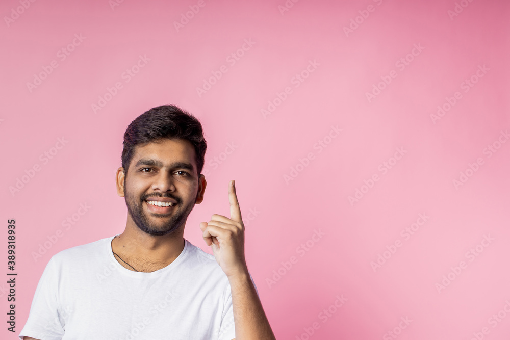 Portrait of handsome Indian guy standing on pink background Portrait of handsome Indian guy standing on pink background