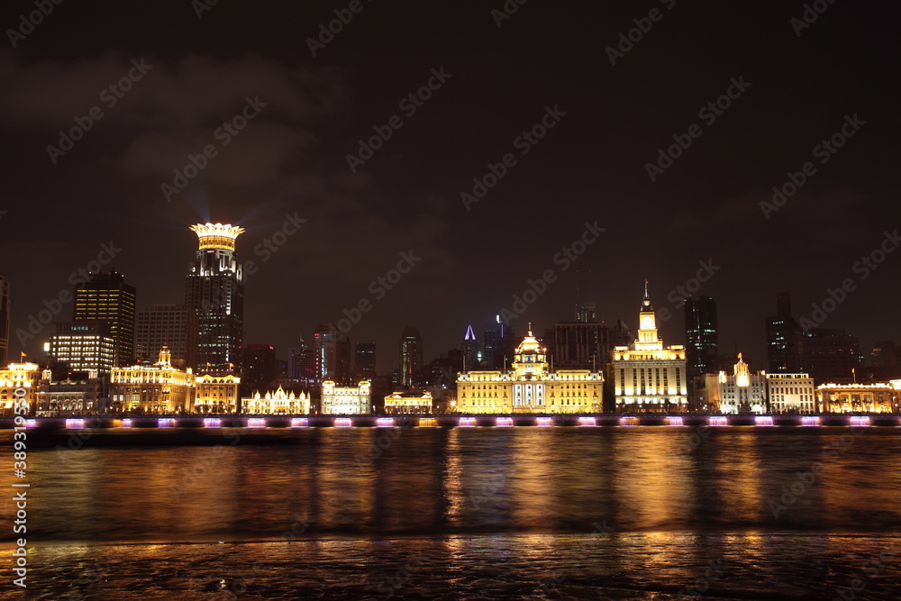 Night view of Shanghai Waitan Skyscrapers with The Custom House and bund center along Huangpu river in Shanghai, China.