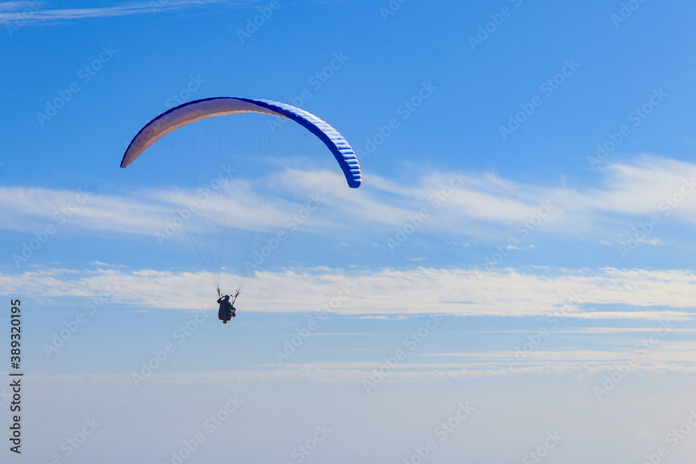 Paragliders in blue sky. Concept of active lifestyle and extreme sport adventure Paragliders in blue sky. Concept of active lifestyle and extreme sport adventure