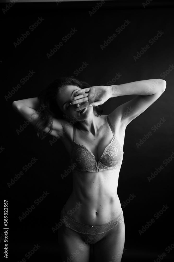 black and white portrait of a young girl on a dark background in the Studio black and white portrait of a young girl on a dark background in the Studio