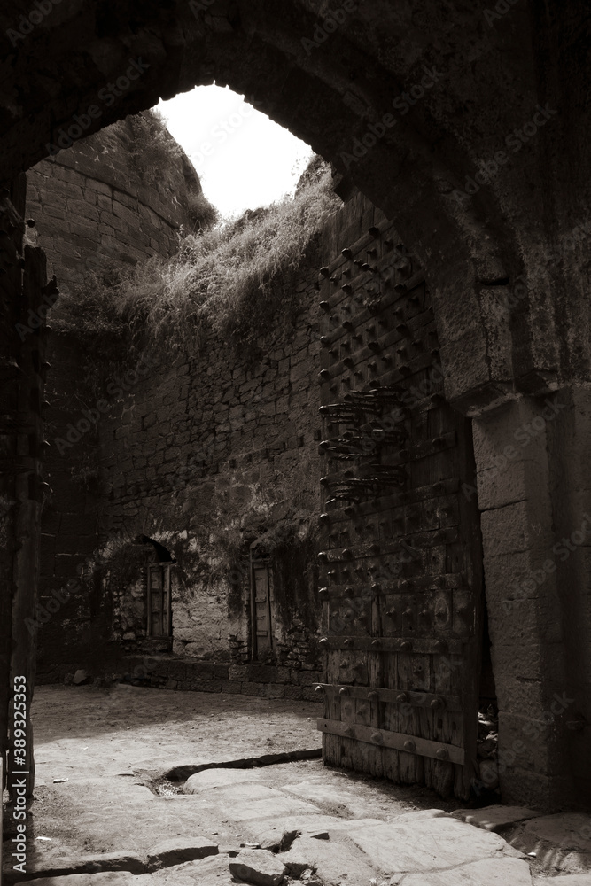 close view of Kalaburagi fort back entrance gate in monochrome stock photo