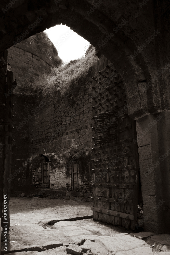 Fototapeta premium close view of Kalaburagi fort back entrance gate in monochrome stock photo