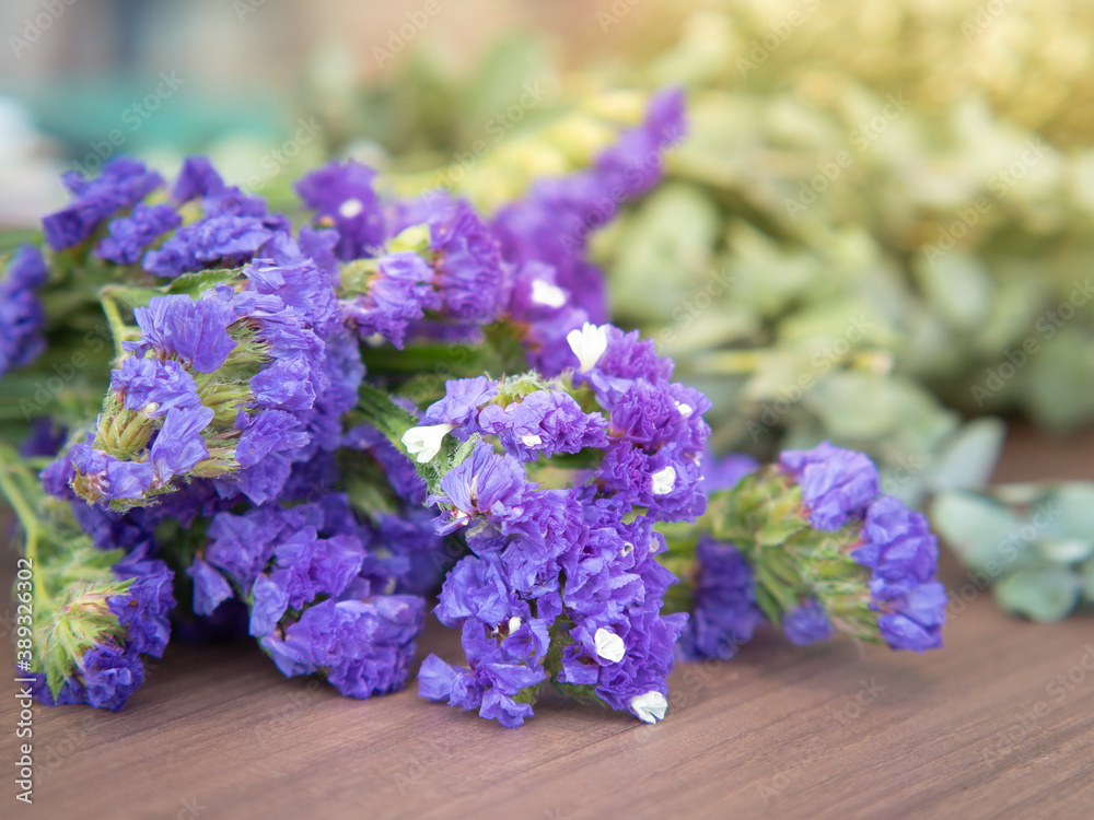 Fototapeta premium Purple satirist flowers on wooden table.