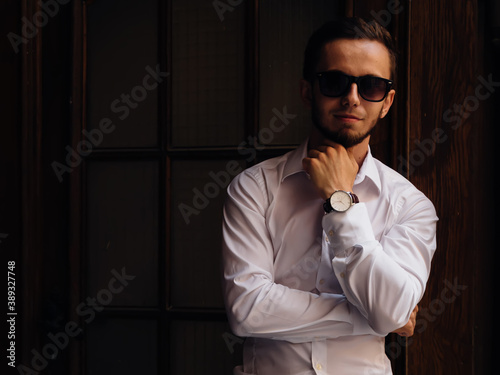 Portrait handsome man wearing black sunglasses and white shirt.
