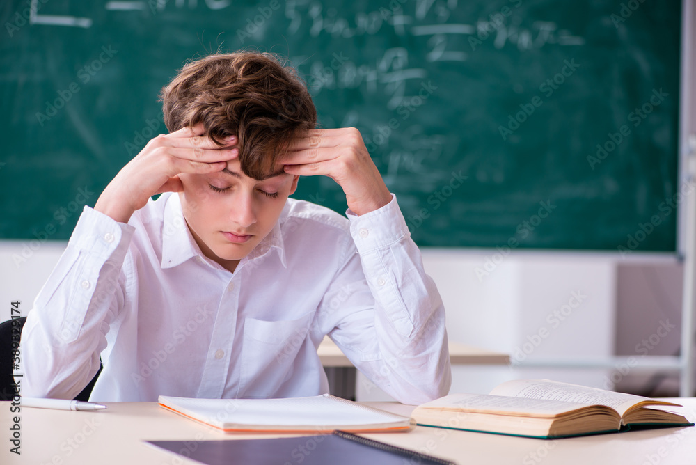 Schoolboy preparing for exams in the classroom Schoolboy preparing for exams in the classroom