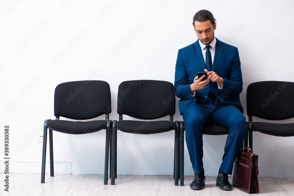 Young businessman waiting for an interview at hall Young businessman waiting for an interview at hall