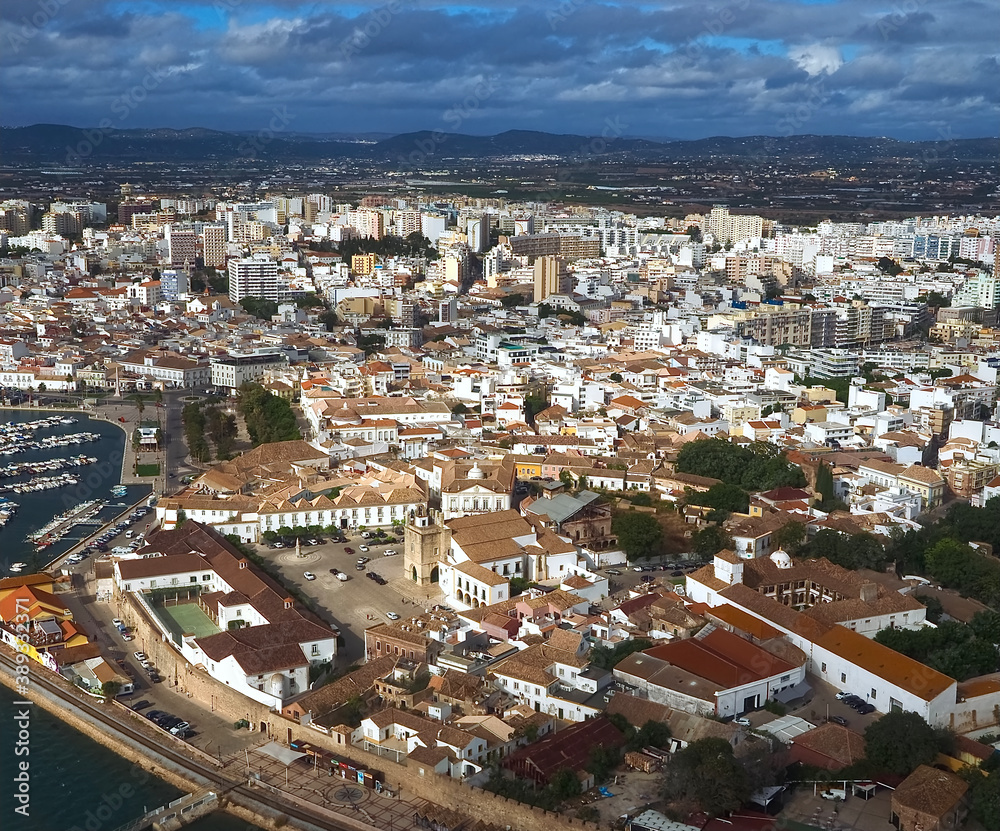 Fototapeta premium Aerial view of the city of Faro at the beautiful Algarve coast, in Portugal seen on a flight to Faro