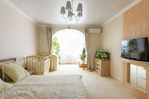 Interior of a spacious bedroom with access to a glazed loggia photo