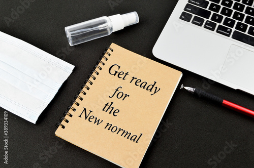 Notebook with written text 'Get Ready for the new normal'. Work and stay at home for new normal concept on Pandemic Covid-19. Coronavirus quarantine concept. photo