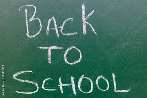 Back To School text on a green board written with chalk