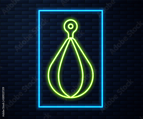 Glowing neon line Punching bag icon isolated on brick wall background. Vector.