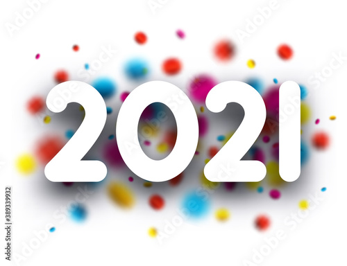 2021 paper sign over blurred round confetti.
