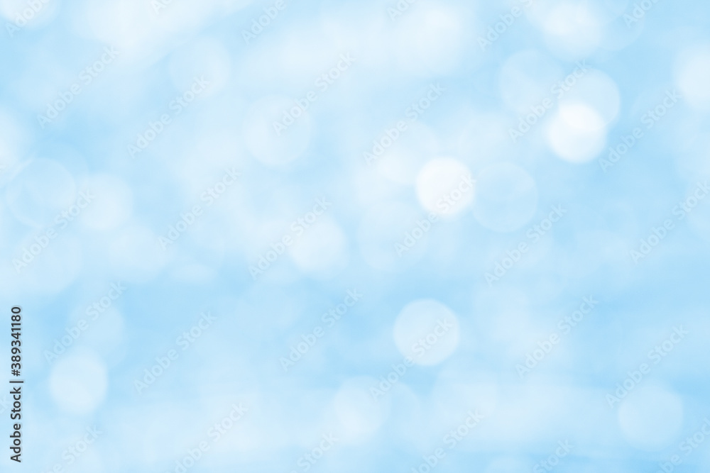 Blue bokeh glitter in blur as background (defocused)
