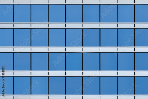 Front view on the glass modern building facade  texture  background 