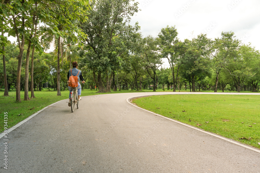 Woman Riding Bicycle in Sukhothai Historical Park Ancient Temples of Thailand