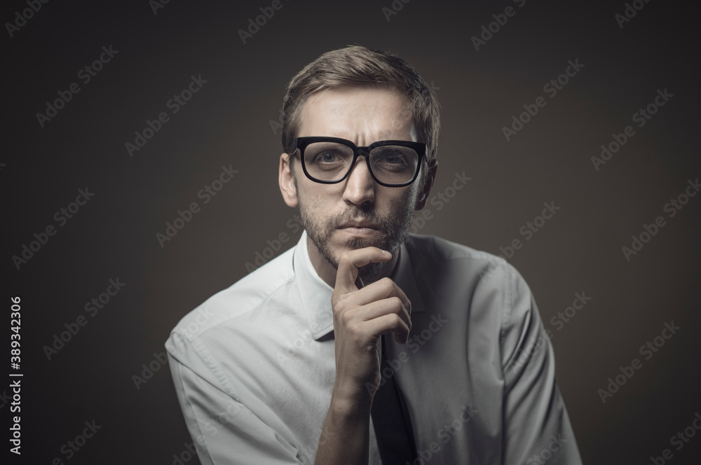 Pensive man with hand on chin Pensive man with hand on chin