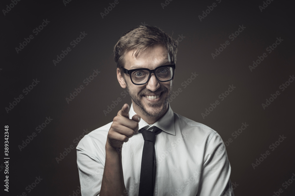 Businessman smiling and pointing at camera Businessman smiling and pointing at camera