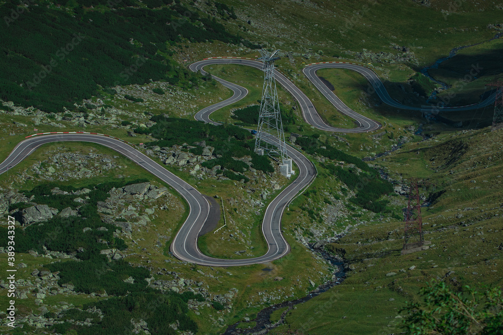 Detail of curves on epic winding road on Transfagarasan pass in Romania in summer time, with twisty road rising up. Road crossing Fagaras mountain range Detail of curves on epic winding road on Transfagarasan pass in Romania in summer time, with twisty road rising up. Road crossing Fagaras mountain range