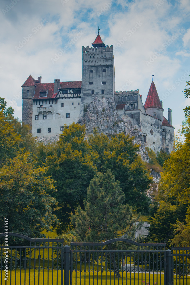 Frog view of Bran castle or famous Dracula's castle, close to Bran, Romania on a cloudy summer day.