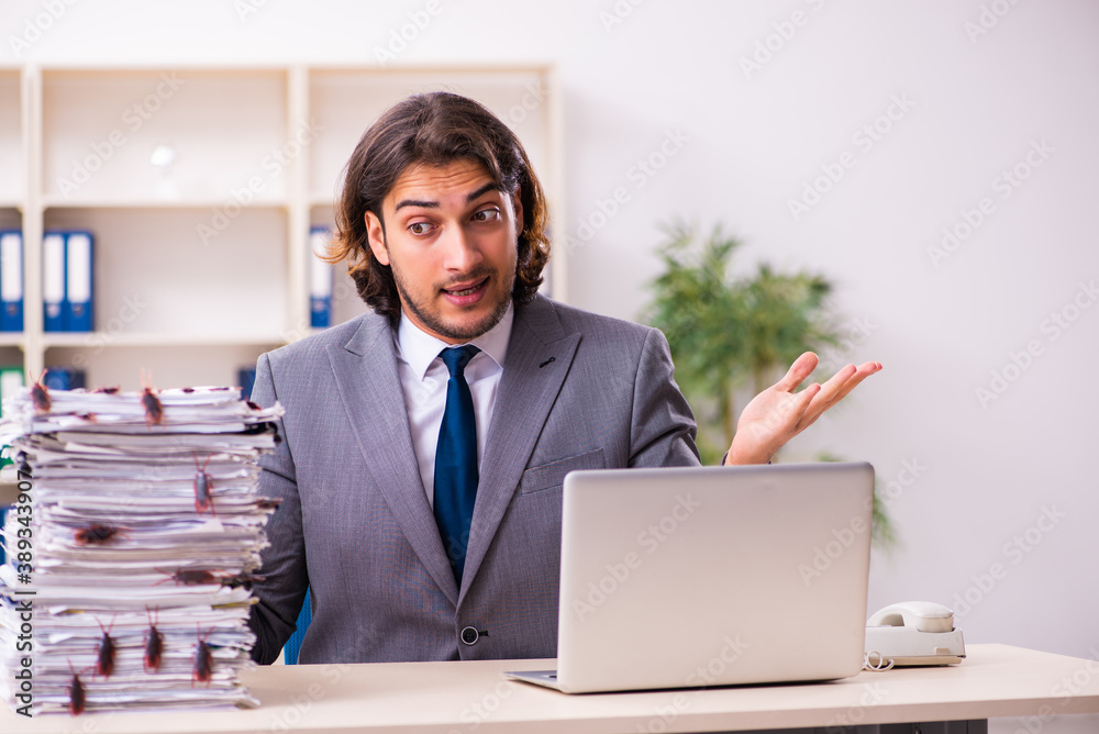 Young male employee and too many cockroaches in the office Young male employee and too many cockroaches in the office