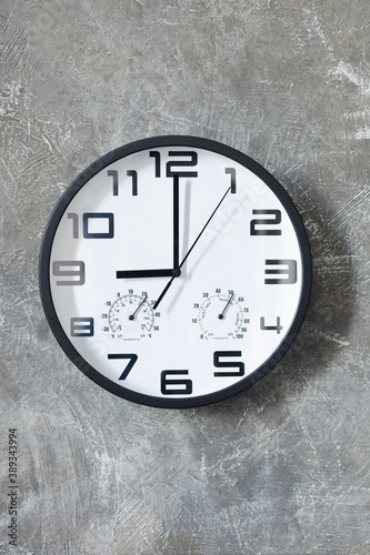 wall clock at concrete or painted background