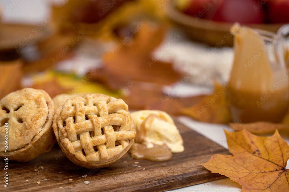 Autumn mini apple pie with lattice, ice cream, caramel sauce and leaves
