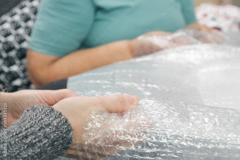 Popping bubble wrap at home.