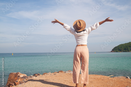 Happy woman standing on the beach,  holiday travel lifestyle and vacation concept