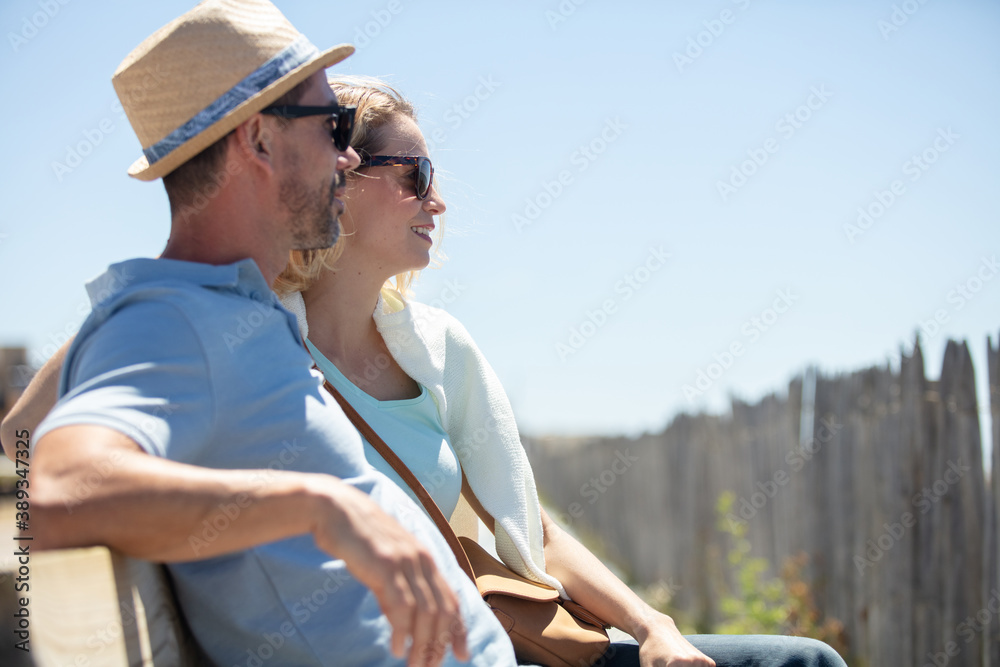 couple sitting on the bench at the seaside
