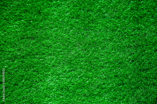 Background Abstract Texture Artificial Grass Summer bright Green color on the Surface of the Football Field in the Stadium for Active Games