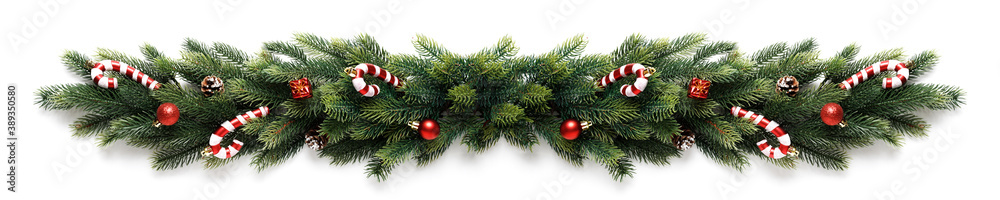 Christmas border frame of tree branches with red balls, pine cones and candies