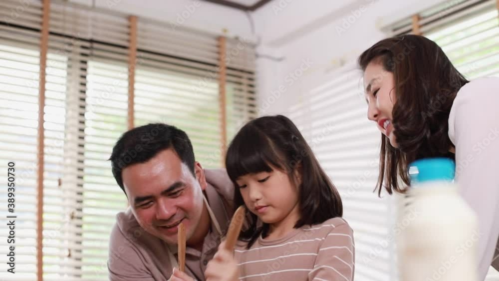 Happy family enjoy cooking salad spending time together for breakfast meal in modern kitchen home in the morning. Happy family enjoy cooking salad spending time together for breakfast meal in modern kitchen home in the morning.