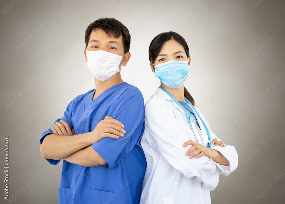 portrait of two doctors, a man and a woman, with lab coats, masks and stethoscope working against the coronavirus portrait of two doctors, a man and a woman, with lab coats, masks and stethoscope working against the coronavirus