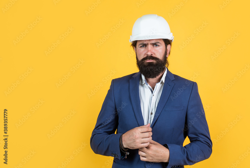 smart businessman in formal suit and safety helmet on yellow background with copy space, building smart businessman in formal suit and safety helmet on yellow background with copy space, building