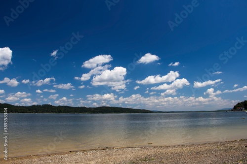 Fototapeta Naklejka Na Ścianę i Meble -  Summertime clouds above lake