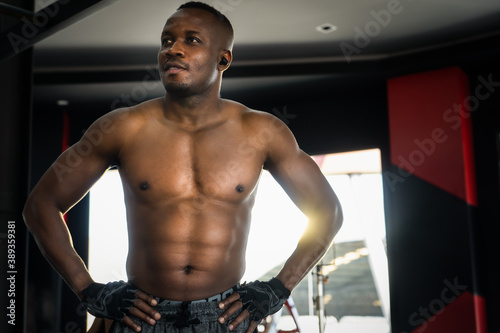 Portrait of muscular black athlete man in fitness gym