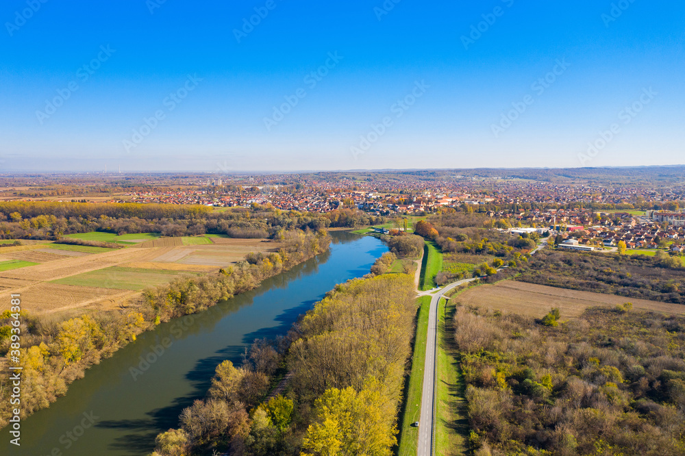 Beautiful countryside landscape in Croatia in autumn, Kupa river and Petrinja town in background, aerial from drone
