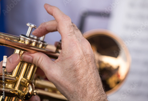 Close up of a musicians hand playing the trumpet