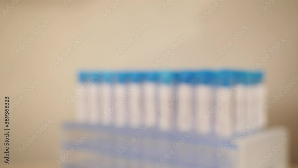 Inspecting a label on a Covid19 test tube. Close up. Inspecting a label on a Covid19 test tube. Close up.